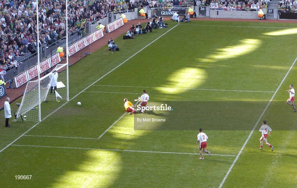 25 September 2005; Dara O Cinneide, Kerry, scores his sides first goal despite the challenge of goalkeeper Pascal McConnell and Michael McGee (4), Tyrone. Bank of Ireland All-Ireland Senior Football Championship Final, Kerry v Tyrone, Croke Park, Dublin. Picture credit; Matt Browne / SPORTSFILE *** Local Caption *** Any photograph taken by SPORTSFILE during, or in connection with, the 2005 Bank of Ireland All-Ireland Senior Football Final which displays GAA logos or contains an image or part of an image of any GAA intellectual property, or, which contains images of a GAA player/players in their playing uniforms, may only be used for editorial and non-advertising purposes.  Use of photographs for advertising, as posters or for purchase separately is strictly prohibited unless prior written approval has been obtained from the Gaelic Athletic Association.