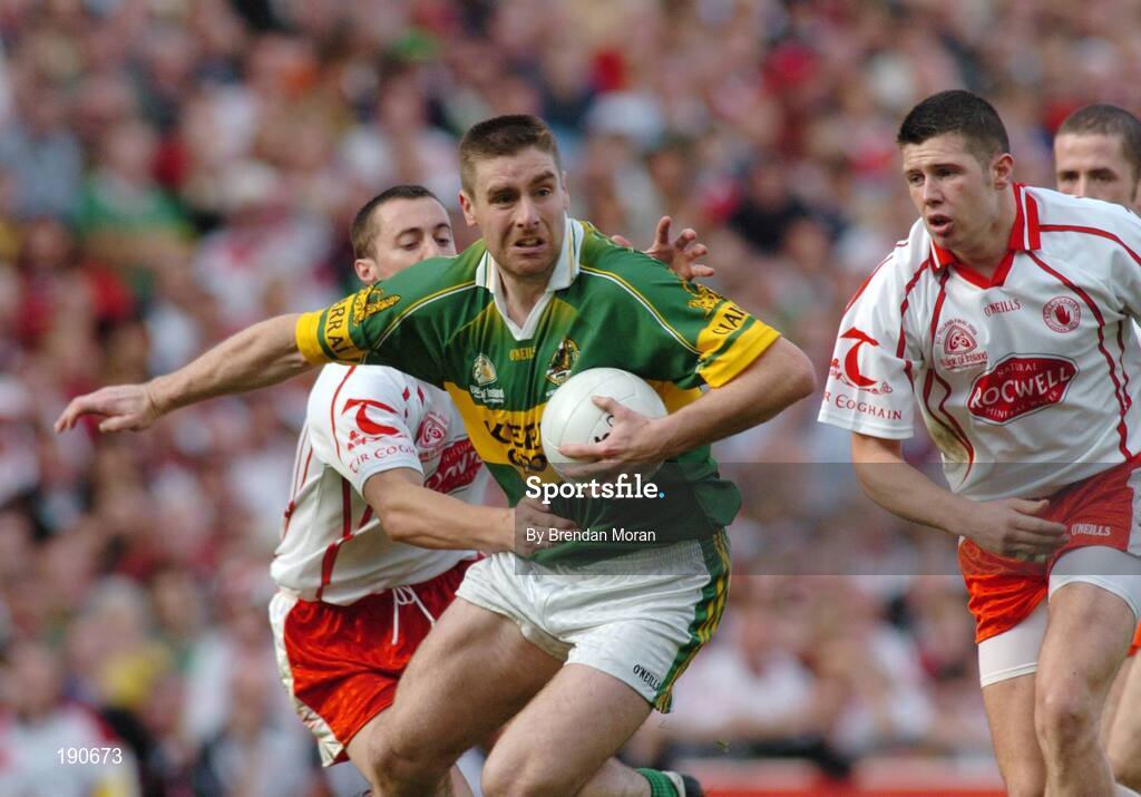 25 September 2005; Darragh O Se, Kerry, in action against Brian McGuigan, left, and Sean Cavanagh, Tyrone. Bank of Ireland All-Ireland Senior Football Championship Final, Kerry v Tyrone, Croke Park, Dublin. Picture credit; Brendan Moran / SPORTSFILE *** Local Caption *** Any photograph taken by SPORTSFILE during, or in connection with, the 2005 Bank of Ireland All-Ireland Senior Football Final which displays GAA logos or contains an image or part of an image of any GAA intellectual property, or, which contains images of a GAA player/players in their playing uniforms, may only be used for editorial and non-advertising purposes.  Use of photographs for advertising, as posters or for purchase separately is strictly prohibited unless prior written approval has been obtained from the Gaelic Athletic Association.