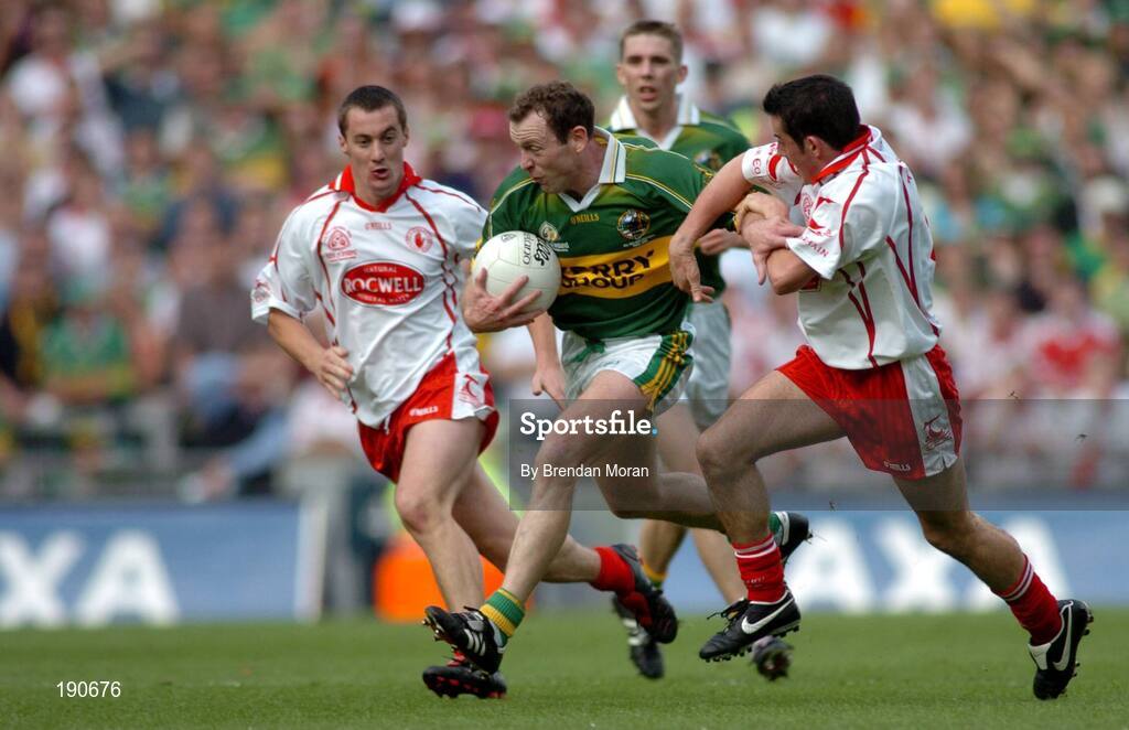 25 September 2005; Seamus Moynihan, Kerry, in action against Brian McGuigan, left, and Davy Harte, Tyrone. Bank of Ireland All-Ireland Senior Football Championship Final, Kerry v Tyrone, Croke Park, Dublin. Picture credit; Brendan Moran / SPORTSFILE *** Local Caption *** Any photograph taken by SPORTSFILE during, or in connection with, the 2005 Bank of Ireland All-Ireland Senior Football Final which displays GAA logos or contains an image or part of an image of any GAA intellectual property, or, which contains images of a GAA player/players in their playing uniforms, may only be used for editorial and non-advertising purposes.  Use of photographs for advertising, as posters or for purchase separately is strictly prohibited unless prior written approval has been obtained from the Gaelic Athletic Association.