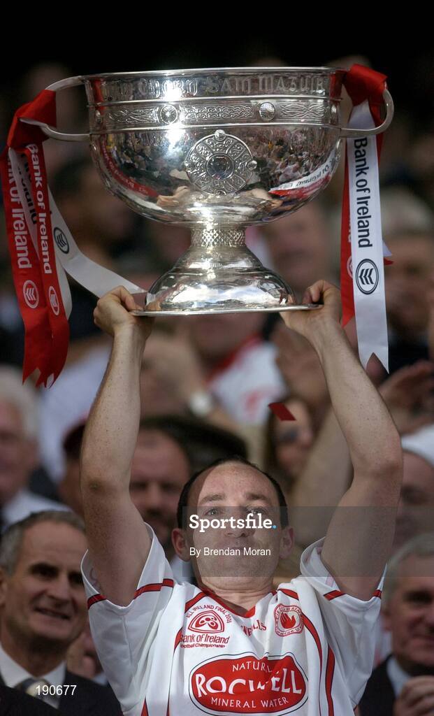 25 September 2005; Tyrone captain Brian Dooher lifts the Sam Maguire Cup after the Bank of Ireland All-Ireland Senior Football Championship Final match between Kerry and Tyrone at Croke Park in Dublin. Photo by Brendan Moran/Sportsfile *** Local Caption *** Any photograph taken by SPORTSFILE during, or in connection with, the 2005 Bank of Ireland All-Ireland Senior Football Final which displays GAA logos or contains an image or part of an image of any GAA intellectual property, or, which contains images of a GAA player/players in their playing uniforms, may only be used for editorial and non-advertising purposes.  Use of photographs for advertising, as posters or for purchase separately is strictly prohibited unless prior written approval has been obtained from the Gaelic Athletic Association.