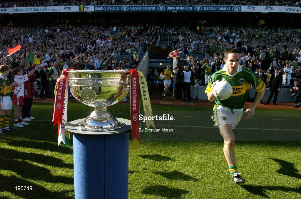 25 September 2005; Kerry captain Declan O'Sullivan runs past the Sam Maguire Cup before the game. Bank of Ireland All-Ireland Senior Football Championship Final, Kerry v Tyrone, Croke Park, Dublin. Picture credit; Brendan Moran / SPORTSFILE *** Local Caption *** Any photograph taken by SPORTSFILE during, or in connection with, the 2005 Bank of Ireland All-Ireland Senior Football Final which displays GAA logos or contains an image or part of an image of any GAA intellectual property, or, which contains images of a GAA player/players in their playing uniforms, may only be used for editorial and non-advertising purposes.  Use of photographs for advertising, as posters or for purchase separately is strictly prohibited unless prior written approval has been obtained from the Gaelic Athletic Association.