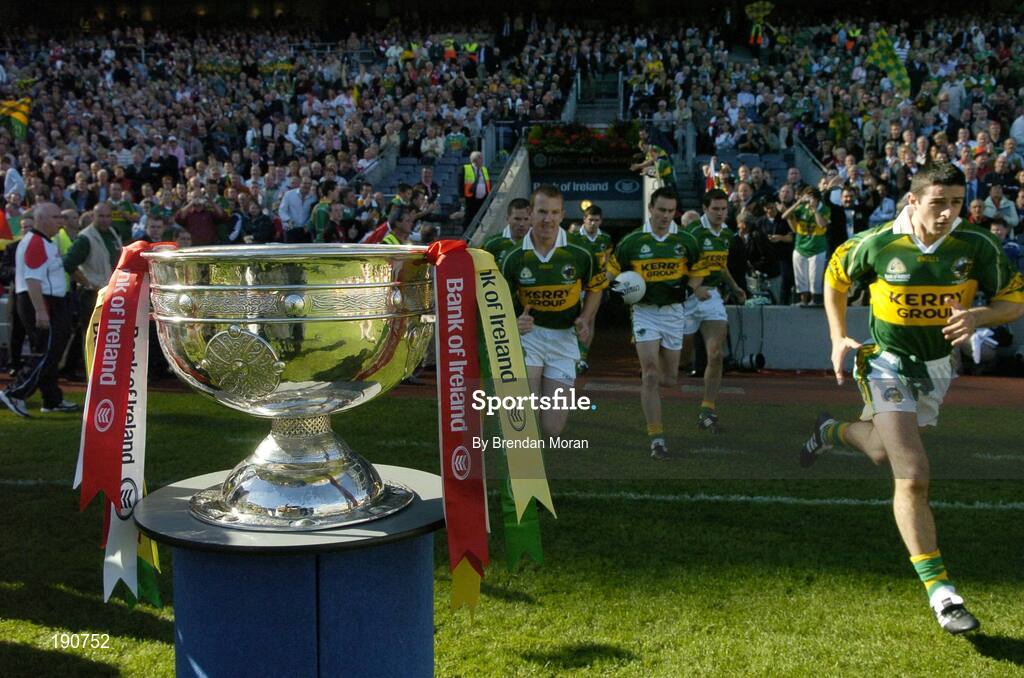 25 September 2005; Kerry players, led by Aidan O'Mahony, right, make their way past the Sam Maguire Cup and out onto the pitch before the game. Bank of Ireland All-Ireland Senior Football Championship Final, Kerry v Tyrone, Croke Park, Dublin. Picture credit; Brendan Moran / SPORTSFILE *** Local Caption *** Any photograph taken by SPORTSFILE during, or in connection with, the 2005 Bank of Ireland All-Ireland Senior Football Final which displays GAA logos or contains an image or part of an image of any GAA intellectual property, or, which contains images of a GAA player/players in their playing uniforms, may only be used for editorial and non-advertising purposes.  Use of photographs for advertising, as posters or for purchase separately is strictly prohibited unless prior written approval has been obtained from the Gaelic Athletic Association.