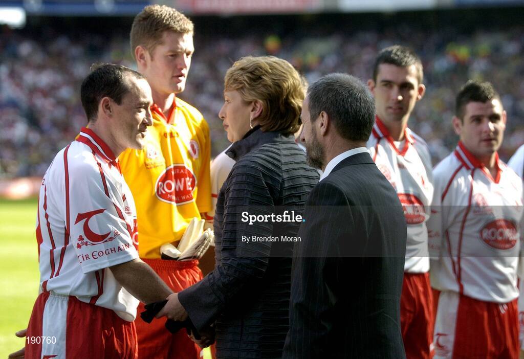 25 September 2005; President Mary McAleese, accompanied by Sean Kelly, President of the GAA, is greeted by Tyrone captain Brian Dooher before meeting the teams. Bank of Ireland All-Ireland Senior Football Championship Final, Kerry v Tyrone, Croke Park, Dublin. Picture credit; Brendan Moran / SPORTSFILE *** Local Caption *** Any photograph taken by SPORTSFILE during, or in connection with, the 2005 Bank of Ireland All-Ireland Senior Football Final which displays GAA logos or contains an image or part of an image of any GAA intellectual property, or, which contains images of a GAA player/players in their playing uniforms, may only be used for editorial and non-advertising purposes.  Use of photographs for advertising, as posters or for purchase separately is strictly prohibited unless prior written approval has been obtained from the Gaelic Athletic Association.