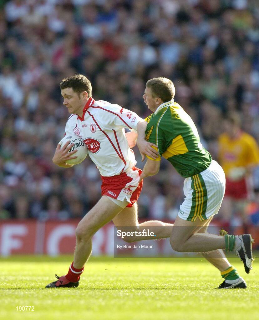 25 September 2005; Enda McGinley, Tyrone, in action against Tomas O Se, Kerry. Bank of Ireland All-Ireland Senior Football Championship Final, Kerry v Tyrone, Croke Park, Dublin. Picture credit; Brendan Moran / SPORTSFILE *** Local Caption *** Any photograph taken by SPORTSFILE during, or in connection with, the 2005 Bank of Ireland All-Ireland Senior Football Final which displays GAA logos or contains an image or part of an image of any GAA intellectual property, or, which contains images of a GAA player/players in their playing uniforms, may only be used for editorial and non-advertising purposes.  Use of photographs for advertising, as posters or for purchase separately is strictly prohibited unless prior written approval has been obtained from the Gaelic Athletic Association.
