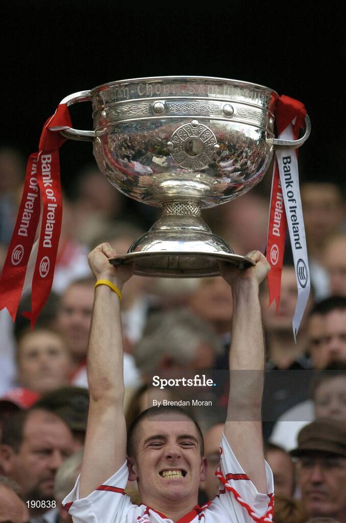 25 September 2005; Tyrone's Philip Jordan lifts the Sam Maguire Cup after the game. Bank of Ireland All-Ireland Senior Football Championship Final, Kerry v Tyrone, Croke Park, Dublin. Picture credit; Brendan Moran / SPORTSFILE *** Local Caption *** Any photograph taken by SPORTSFILE during, or in connection with, the 2005 Bank of Ireland All-Ireland Senior Football Final which displays GAA logos or contains an image or part of an image of any GAA intellectual property, or, which contains images of a GAA player/players in their playing uniforms, may only be used for editorial and non-advertising purposes.  Use of photographs for advertising, as posters or for purchase separately is strictly prohibited unless prior written approval has been obtained from the Gaelic Athletic Association.