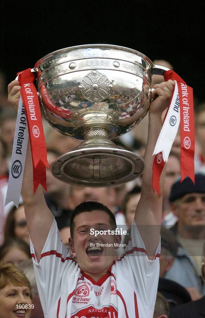 25 September 2005; Tyrone's Sean Cavanagh lifts the Sam Maguire Cup after the game. Bank of Ireland All-Ireland Senior Football Championship Final, Kerry v Tyrone, Croke Park, Dublin. Picture credit; Brendan Moran / SPORTSFILE *** Local Caption *** Any photograph taken by SPORTSFILE during, or in connection with, the 2005 Bank of Ireland All-Ireland Senior Football Final which displays GAA logos or contains an image or part of an image of any GAA intellectual property, or, which contains images of a GAA player/players in their playing uniforms, may only be used for editorial and non-advertising purposes.  Use of photographs for advertising, as posters or for purchase separately is strictly prohibited unless prior written approval has been obtained from the Gaelic Athletic Association.