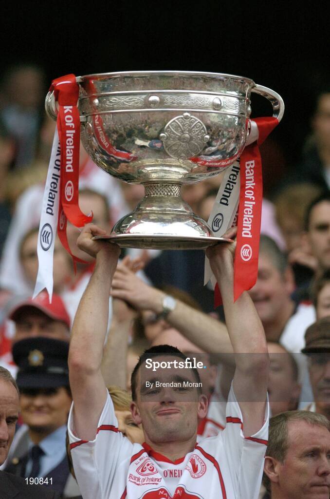 25 September 2005; Tyrone's Ryan McMenamin lifts the Sam Maguire Cup after the game. Bank of Ireland All-Ireland Senior Football Championship Final, Kerry v Tyrone, Croke Park, Dublin. Picture credit; Brendan Moran / SPORTSFILE *** Local Caption *** Any photograph taken by SPORTSFILE during, or in connection with, the 2005 Bank of Ireland All-Ireland Senior Football Final which displays GAA logos or contains an image or part of an image of any GAA intellectual property, or, which contains images of a GAA player/players in their playing uniforms, may only be used for editorial and non-advertising purposes.  Use of photographs for advertising, as posters or for purchase separately is strictly prohibited unless prior written approval has been obtained from the Gaelic Athletic Association.