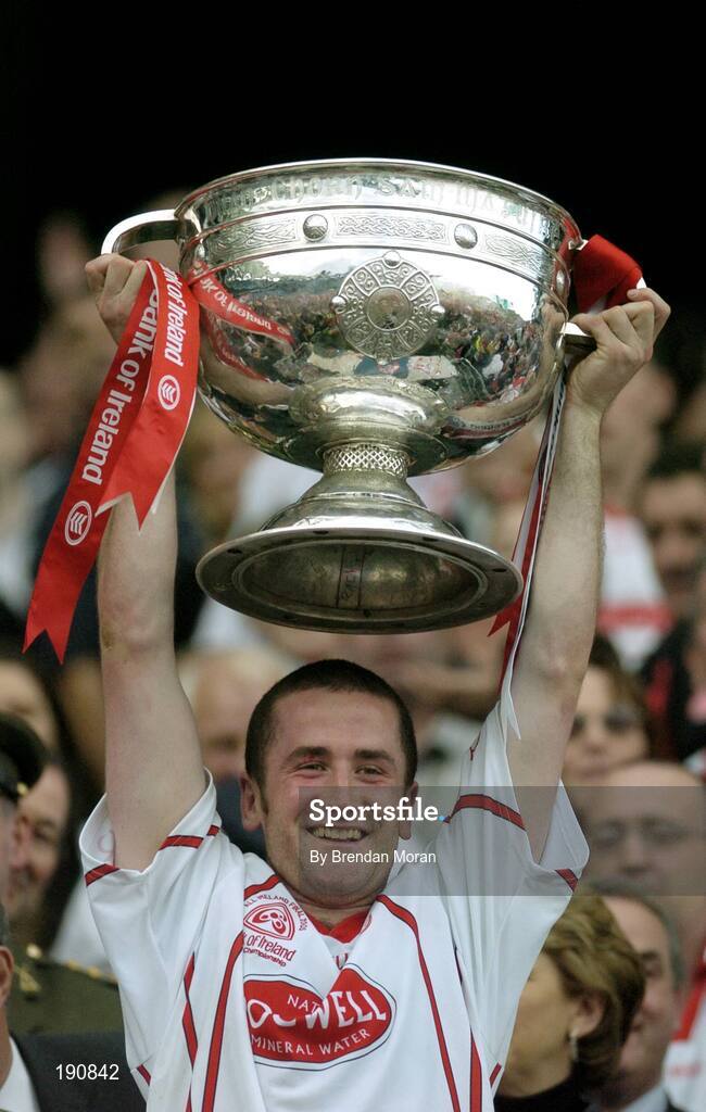 25 September 2005; Tyrone's Stephen O'Neill lifts the Sam Maguire Cup after the game. Bank of Ireland All-Ireland Senior Football Championship Final, Kerry v Tyrone, Croke Park, Dublin. Picture credit; Brendan Moran / SPORTSFILE *** Local Caption *** Any photograph taken by SPORTSFILE during, or in connection with, the 2005 Bank of Ireland All-Ireland Senior Football Final which displays GAA logos or contains an image or part of an image of any GAA intellectual property, or, which contains images of a GAA player/players in their playing uniforms, may only be used for editorial and non-advertising purposes.  Use of photographs for advertising, as posters or for purchase separately is strictly prohibited unless prior written approval has been obtained from the Gaelic Athletic Association.