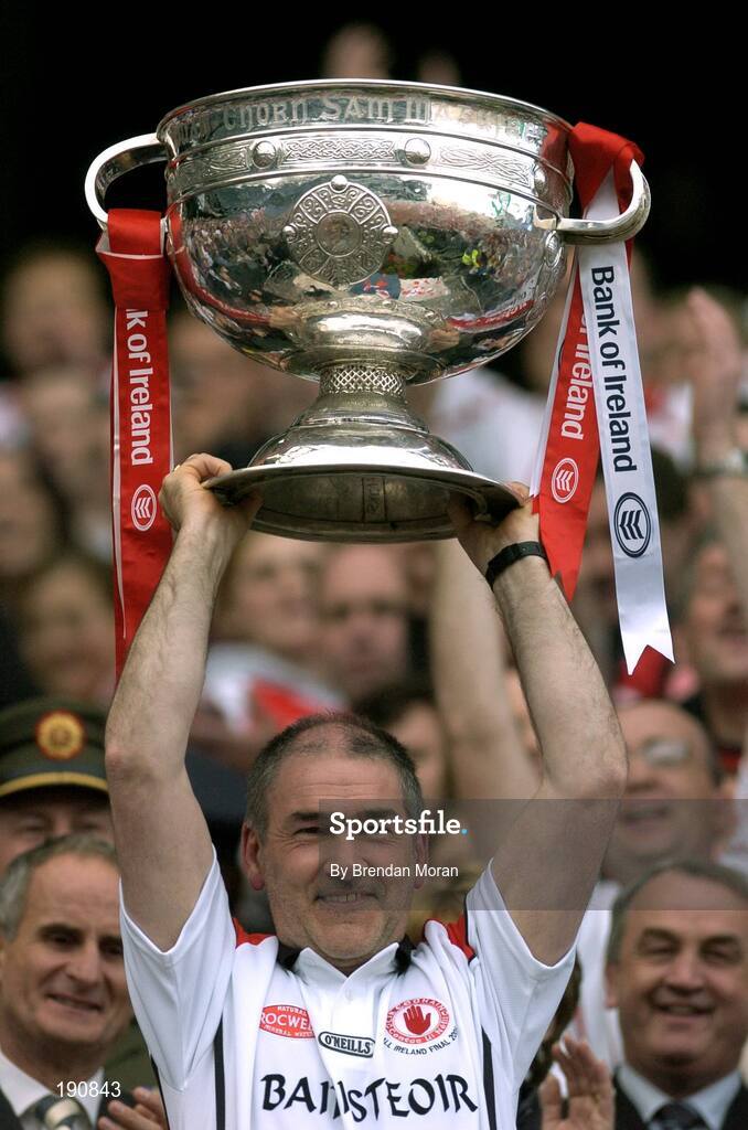 25 September 2005; Tyrone manager Mickey Harte lifts the Sam Maguire Cup after the game. Bank of Ireland All-Ireland Senior Football Championship Final, Kerry v Tyrone, Croke Park, Dublin. Picture credit; Brendan Moran / SPORTSFILE *** Local Caption *** Any photograph taken by SPORTSFILE during, or in connection with, the 2005 Bank of Ireland All-Ireland Senior Football Final which displays GAA logos or contains an image or part of an image of any GAA intellectual property, or, which contains images of a GAA player/players in their playing uniforms, may only be used for editorial and non-advertising purposes.  Use of photographs for advertising, as posters or for purchase separately is strictly prohibited unless prior written approval has been obtained from the Gaelic Athletic Association.