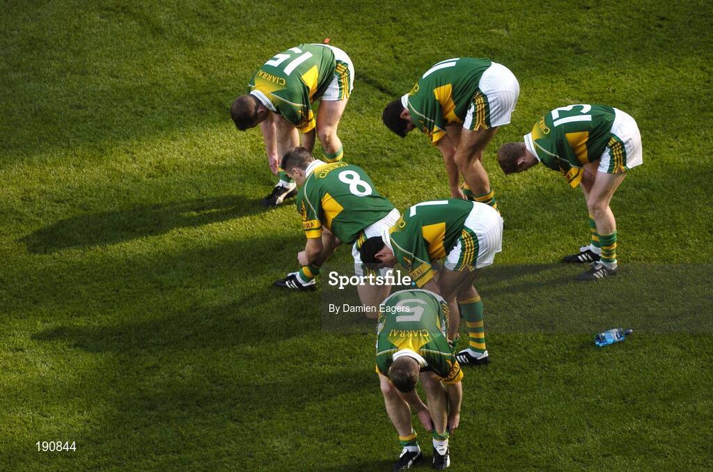 25 September 2005; Kerry players adjust their socks after the parade. Bank of Ireland All-Ireland Senior Football Championship Final, Kerry v Tyrone, Croke Park, Dublin. Picture credit; Damien Eagers/ SPORTSFILE *** Local Caption *** Any photograph taken by SPORTSFILE during, or in connection with, the 2005 Bank of Ireland All-Ireland Senior Football Final which displays GAA logos or contains an image or part of an image of any GAA intellectual property, or, which contains images of a GAA player/players in their playing uniforms, may only be used for editorial and non-advertising purposes.  Use of photographs for advertising, as posters or for purchase separately is strictly prohibited unless prior written approval has been obtained from the Gaelic Athletic Association.