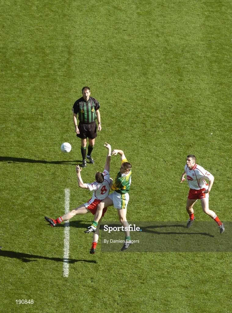 25 September 2005; Referee Michael Monahan throws the ball in between Kerry's Darragh O'Se and Tyrone's Enda McGinley as Sean Cavanagh, Tyrone, awaits the breaking ball. Bank of Ireland All-Ireland Senior Football Championship Final, Kerry v Tyrone, Croke Park, Dublin. Picture credit; Damien Eagers/ SPORTSFILE *** Local Caption *** Any photograph taken by SPORTSFILE during, or in connection with, the 2005 Bank of Ireland All-Ireland Senior Football Final which displays GAA logos or contains an image or part of an image of any GAA intellectual property, or, which contains images of a GAA player/players in their playing uniforms, may only be used for editorial and non-advertising purposes.  Use of photographs for advertising, as posters or for purchase separately is strictly prohibited unless prior written approval has been obtained from the Gaelic Athletic Association.