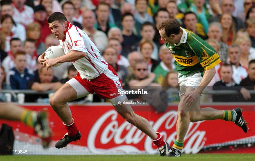 25 September 2005; Sean Cavanagh, Tyrone, in action against Seamus Moynihan, Kerry. Bank of Ireland All-Ireland Senior Football Championship Final, Kerry v Tyrone, Croke Park, Dublin. Picture credit; Brendan Moran / SPORTSFILE *** Local Caption *** Any photograph taken by SPORTSFILE during, or in connection with, the 2005 Bank of Ireland All-Ireland Senior Football Final which displays GAA logos or contains an image or part of an image of any GAA intellectual property, or, which contains images of a GAA player/players in their playing uniforms, may only be used for editorial and non-advertising purposes.  Use of photographs for advertising, as posters or for purchase separately is strictly prohibited unless prior written approval has been obtained from the Gaelic Athletic Association.