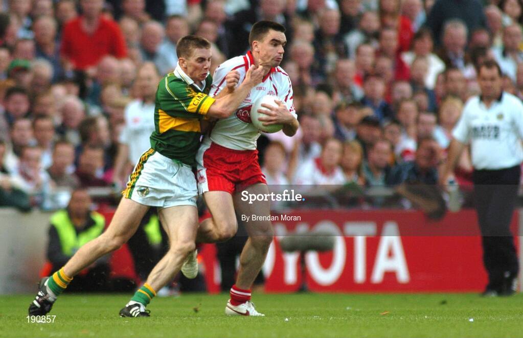 25 September 2005; Ryan McMenamin, Tyrone, is tackled by Marc O Se, Kerry. Bank of Ireland All-Ireland Senior Football Championship Final, Kerry v Tyrone, Croke Park, Dublin. Picture credit; Brendan Moran / SPORTSFILE *** Local Caption *** Any photograph taken by SPORTSFILE during, or in connection with, the 2005 Bank of Ireland All-Ireland Senior Football Final which displays GAA logos or contains an image or part of an image of any GAA intellectual property, or, which contains images of a GAA player/players in their playing uniforms, may only be used for editorial and non-advertising purposes.  Use of photographs for advertising, as posters or for purchase separately is strictly prohibited unless prior written approval has been obtained from the Gaelic Athletic Association.