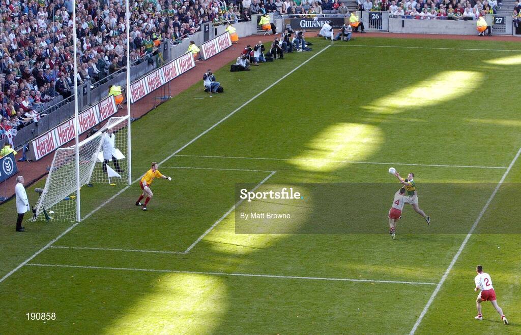 25 September 2005; Dara O Cinneide, Kerry, catches the ball ahead of Michael McGee, Tyrone, on his way to scoring his sides first goal. Bank of Ireland All-Ireland Senior Football Championship Final, Kerry v Tyrone, Croke Park, Dublin. Picture credit; Matt Browne / SPORTSFILE *** Local Caption *** Any photograph taken by SPORTSFILE during, or in connection with, the 2005 Bank of Ireland All-Ireland Senior Football Final which displays GAA logos or contains an image or part of an image of any GAA intellectual property, or, which contains images of a GAA player/players in their playing uniforms, may only be used for editorial and non-advertising purposes.  Use of photographs for advertising, as posters or for purchase separately is strictly prohibited unless prior written approval has been obtained from the Gaelic Athletic Association.