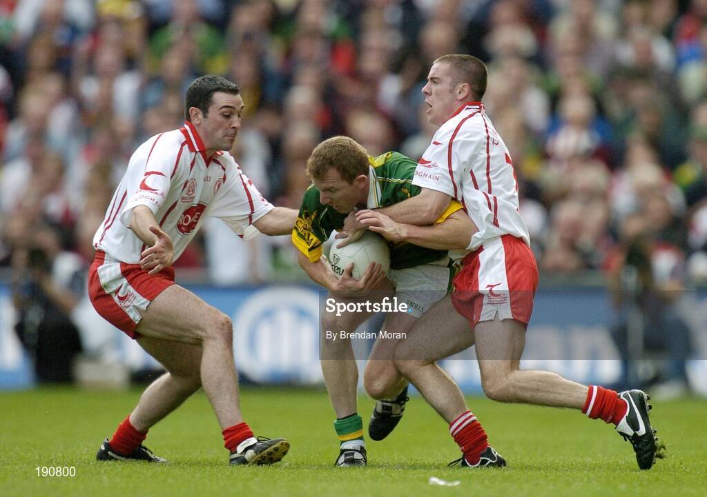 25 September 2005; Liam Hassett, Kerry, in action against Ryan Mellon, left, and Philip Jordan, Tyrone. Bank of Ireland All-Ireland Senior Football Championship Final, Kerry v Tyrone, Croke Park, Dublin. Picture credit; Brendan Moran / SPORTSFILE *** Local Caption *** Any photograph taken by SPORTSFILE during, or in connection with, the 2005 Bank of Ireland All-Ireland Senior Football Final which displays GAA logos or contains an image or part of an image of any GAA intellectual property, or, which contains images of a GAA player/players in their playing uniforms, may only be used for editorial and non-advertising purposes.  Use of photographs for advertising, as posters or for purchase separately is strictly prohibited unless prior written approval has been obtained from the Gaelic Athletic Association.