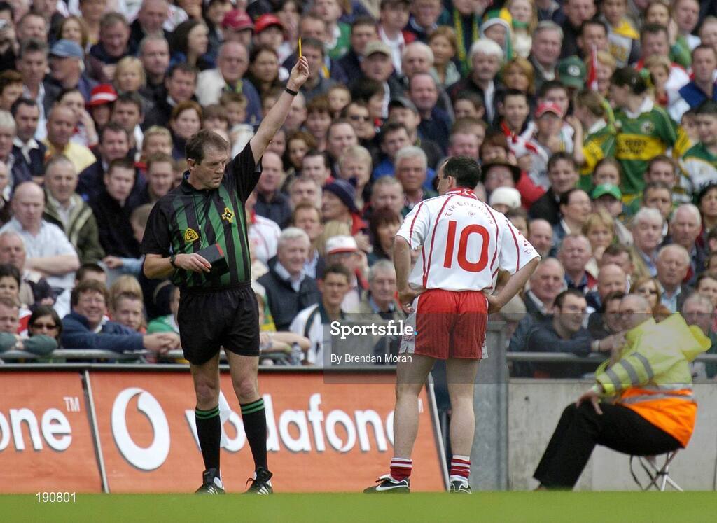 25 September 2005; Tyrone captain Brian Dooher is shown a yelow card by referee Michael Monahan. Bank of Ireland All-Ireland Senior Football Championship Final, Kerry v Tyrone, Croke Park, Dublin. Picture credit; Brendan Moran / SPORTSFILE *** Local Caption *** Any photograph taken by SPORTSFILE during, or in connection with, the 2005 Bank of Ireland All-Ireland Senior Football Final which displays GAA logos or contains an image or part of an image of any GAA intellectual property, or, which contains images of a GAA player/players in their playing uniforms, may only be used for editorial and non-advertising purposes.  Use of photographs for advertising, as posters or for purchase separately is strictly prohibited unless prior written approval has been obtained from the Gaelic Athletic Association.