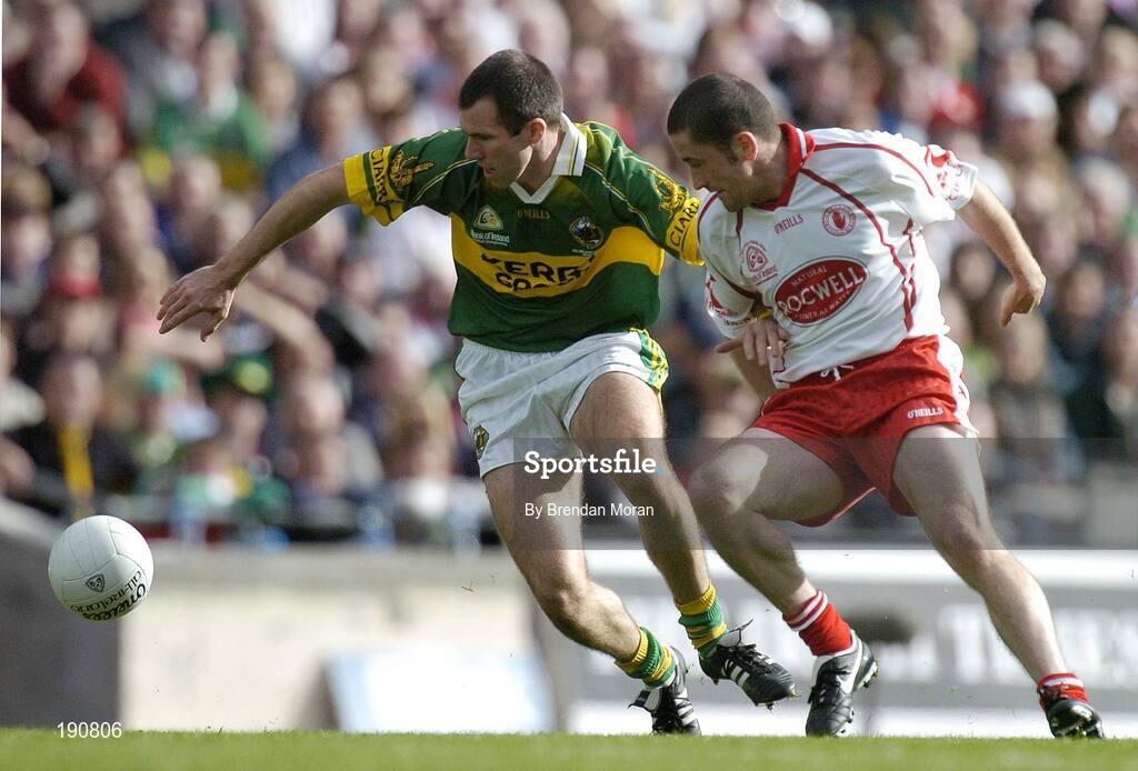 25 September 2005; Michael McCarthy, Kerry, holds off the challenge of Stephen O'Neill, Tyrone. Bank of Ireland All-Ireland Senior Football Championship Final, Kerry v Tyrone, Croke Park, Dublin. Picture credit; Brendan Moran / SPORTSFILE *** Local Caption *** Any photograph taken by SPORTSFILE during, or in connection with, the 2005 Bank of Ireland All-Ireland Senior Football Final which displays GAA logos or contains an image or part of an image of any GAA intellectual property, or, which contains images of a GAA player/players in their playing uniforms, may only be used for editorial and non-advertising purposes.  Use of photographs for advertising, as posters or for purchase separately is strictly prohibited unless prior written approval has been obtained from the Gaelic Athletic Association.