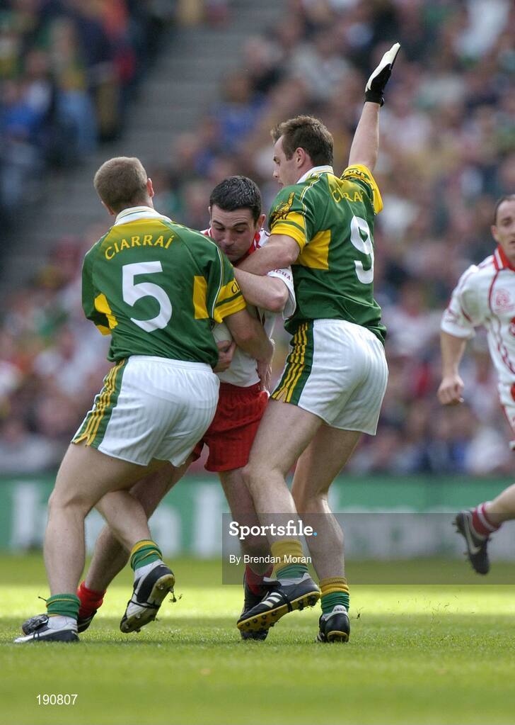 25 September 2005; Ryan Mellon, Tyrone, is tackled by Tomas O Se (5) and William Kirby, Kerry. Bank of Ireland All-Ireland Senior Football Championship Final, Kerry v Tyrone, Croke Park, Dublin. Picture credit; Brendan Moran / SPORTSFILE *** Local Caption *** Any photograph taken by SPORTSFILE during, or in connection with, the 2005 Bank of Ireland All-Ireland Senior Football Final which displays GAA logos or contains an image or part of an image of any GAA intellectual property, or, which contains images of a GAA player/players in their playing uniforms, may only be used for editorial and non-advertising purposes.  Use of photographs for advertising, as posters or for purchase separately is strictly prohibited unless prior written approval has been obtained from the Gaelic Athletic Association.
