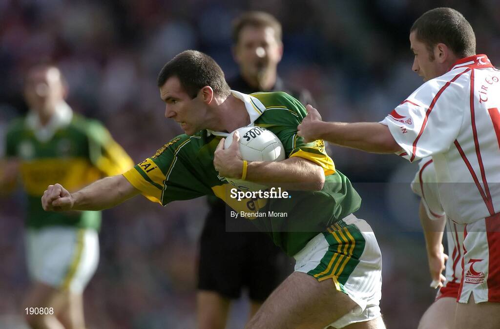 25 September 2005; Michael McCarthy, Kerry, is tackled by Stephen O'Neill, Tyrone. Bank of Ireland All-Ireland Senior Football Championship Final, Kerry v Tyrone, Croke Park, Dublin. Picture credit; Brendan Moran / SPORTSFILE *** Local Caption *** Any photograph taken by SPORTSFILE during, or in connection with, the 2005 Bank of Ireland All-Ireland Senior Football Final which displays GAA logos or contains an image or part of an image of any GAA intellectual property, or, which contains images of a GAA player/players in their playing uniforms, may only be used for editorial and non-advertising purposes.  Use of photographs for advertising, as posters or for purchase separately is strictly prohibited unless prior written approval has been obtained from the Gaelic Athletic Association.