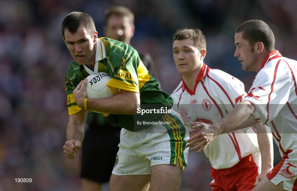 25 September 2005; Michael McCarthy, Kerry, in action against Enda McGinley and Stephen O'Neill, right, Tyrone. Bank of Ireland All-Ireland Senior Football Championship Final, Kerry v Tyrone, Croke Park, Dublin. Picture credit; Brendan Moran / SPORTSFILE *** Local Caption *** Any photograph taken by SPORTSFILE during, or in connection with, the 2005 Bank of Ireland All-Ireland Senior Football Final which displays GAA logos or contains an image or part of an image of any GAA intellectual property, or, which contains images of a GAA player/players in their playing uniforms, may only be used for editorial and non-advertising purposes.  Use of photographs for advertising, as posters or for purchase separately is strictly prohibited unless prior written approval has been obtained from the Gaelic Athletic Association.
