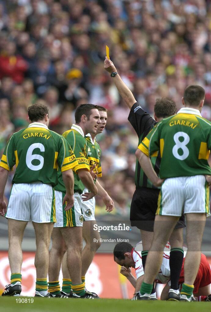 25 September 2005; Declan O'Sullivan, 2nd from left, Kerry, is shown a yellow card by referee Michael Monahan. Bank of Ireland All-Ireland Senior Football Championship Final, Kerry v Tyrone, Croke Park, Dublin. Picture credit; Brendan Moran / SPORTSFILE *** Local Caption *** Any photograph taken by SPORTSFILE during, or in connection with, the 2005 Bank of Ireland All-Ireland Senior Football Final which displays GAA logos or contains an image or part of an image of any GAA intellectual property, or, which contains images of a GAA player/players in their playing uniforms, may only be used for editorial and non-advertising purposes.  Use of photographs for advertising, as posters or for purchase separately is strictly prohibited unless prior written approval has been obtained from the Gaelic Athletic Association.