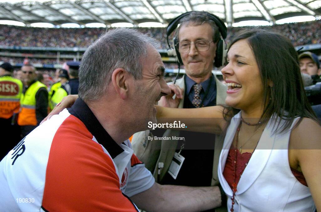 25 September 2005; Tyrone manager Mickey Harte celebrates with his daughter Michaela after the final whistle. Bank of Ireland All-Ireland Senior Football Championship Final, Kerry v Tyrone, Croke Park, Dublin. Picture credit; Brendan Moran / SPORTSFILE *** Local Caption *** Any photograph taken by SPORTSFILE during, or in connection with, the 2005 Bank of Ireland All-Ireland Senior Football Final which displays GAA logos or contains an image or part of an image of any GAA intellectual property, or, which contains images of a GAA player/players in their playing uniforms, may only be used for editorial and non-advertising purposes.  Use of photographs for advertising, as posters or for purchase separately is strictly prohibited unless prior written approval has been obtained from the Gaelic Athletic Association.