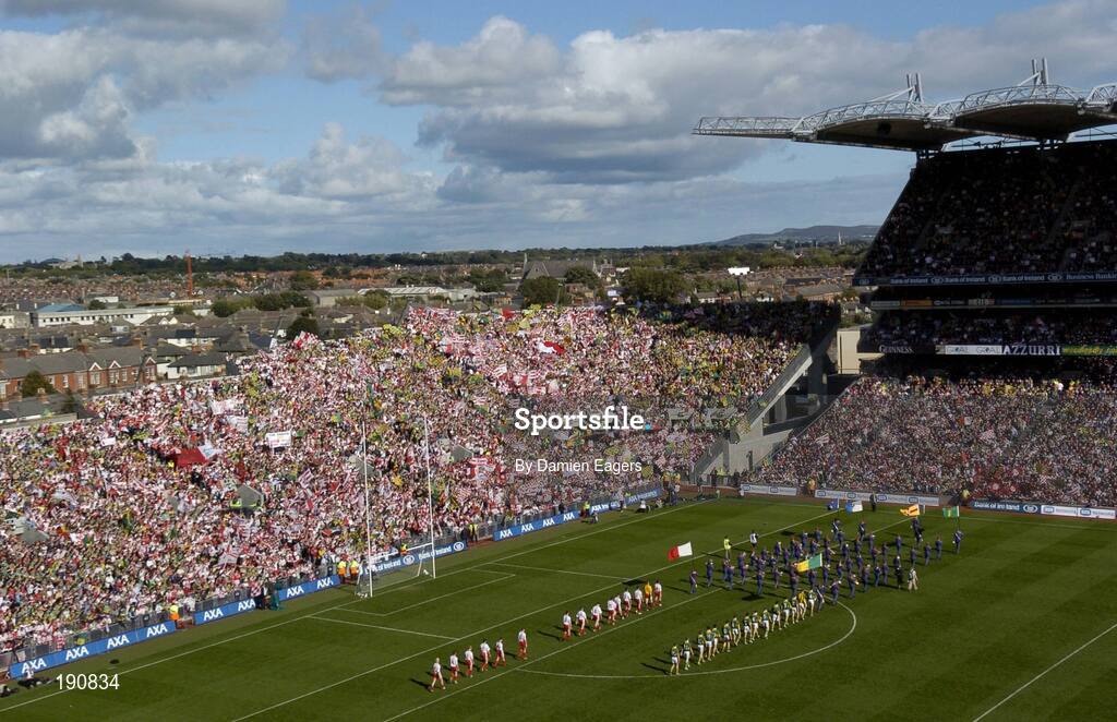 25 September 2005; The Tyrone and Kerry teams walk behind the Artane Band during the pre match parade. Bank of Ireland All-Ireland Senior Football Championship Final, Kerry v Tyrone, Croke Park, Dublin. Picture credit; Damien Eagers/ SPORTSFILE *** Local Caption *** Any photograph taken by SPORTSFILE during, or in connection with, the 2005 Bank of Ireland All-Ireland Senior Football Final which displays GAA logos or contains an image or part of an image of any GAA intellectual property, or, which contains images of a GAA player/players in their playing uniforms, may only be used for editorial and non-advertising purposes.  Use of photographs for advertising, as posters or for purchase separately is strictly prohibited unless prior written approval has been obtained from the Gaelic Athletic Association.
