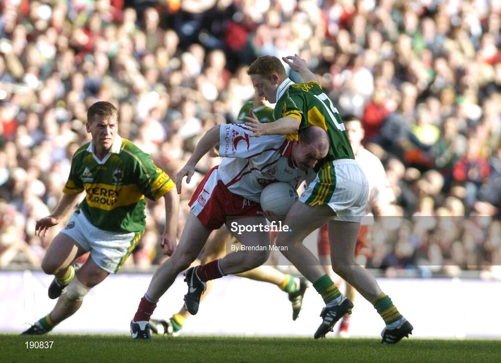 25 September 2005; Chris Lawn, Tyrone, is tackled by Colm Cooper, Kerry. Bank of Ireland All-Ireland Senior Football Championship Final, Kerry v Tyrone, Croke Park, Dublin. Picture credit; Brendan Moran / SPORTSFILE *** Local Caption *** Any photograph taken by SPORTSFILE during, or in connection with, the 2005 Bank of Ireland All-Ireland Senior Football Final which displays GAA logos or contains an image or part of an image of any GAA intellectual property, or, which contains images of a GAA player/players in their playing uniforms, may only be used for editorial and non-advertising purposes.  Use of photographs for advertising, as posters or for purchase separately is strictly prohibited unless prior written approval has been obtained from the Gaelic Athletic Association.