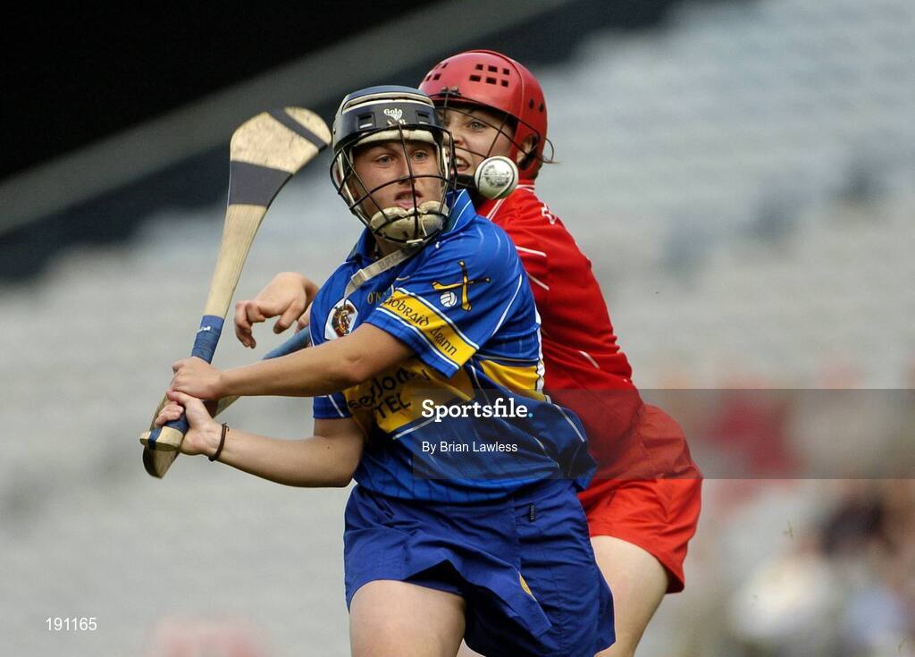 18 September 2005; Jill Horan, Tipperary, in action against Anna Geary, Cork. Tipperary v Cork, All-Ireland Senior Camogie Final, Croke Park, Dublin. Picture credit; Brian Lawless / SPORTSFILE *** Local Caption *** Any photograph taken by SPORTSFILE during, or in connection with, the 2005 Guinness All-Ireland Hurling Final which displays GAA logos or contains an image or part of an image of any GAA intellectual property, or, which contains images of a GAA player/players in their playing uniforms, may only be used for editorial and non-advertising purposes.  Use of photographs for advertising, as posters or for purchase separately is strictly prohibited unless prior written approval has been obtained from the Gaelic Athletic Association.