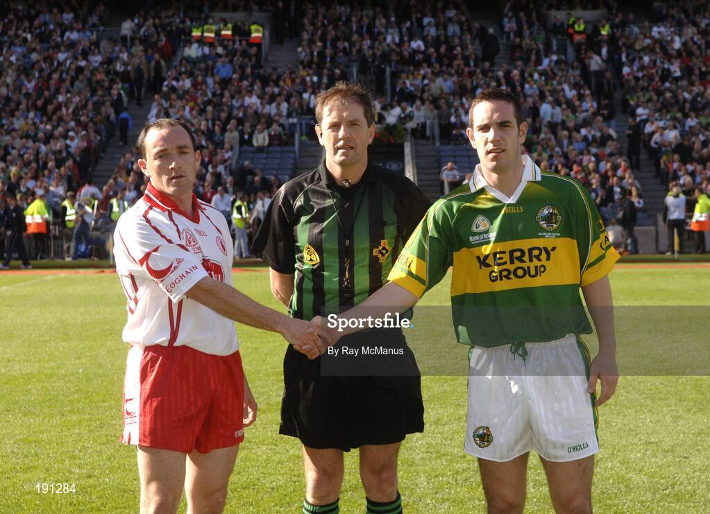 25 September 2005; Kerry captain Declan O'Sullivan shakes hands with Tyrone captain Brian Dooher, left, in front of referee Michael Monahan. Bank of Ireland All-Ireland Senior Football Championship Final, Kerry v Tyrone, Croke Park, Dublin. Picture credit; Ray McManus / SPORTSFILE *** Local Caption *** Any photograph taken by SPORTSFILE during, or in connection with, the 2005 Bank of Ireland All-Ireland Senior Football Final which displays GAA logos or contains an image or part of an image of any GAA intellectual property, or, which contains images of a GAA player/players in their playing uniforms, may only be used for editorial and non-advertising purposes.  Use of photographs for advertising, as posters or for purchase separately is strictly prohibited unless prior written approval has been obtained from the Gaelic Athletic Association.