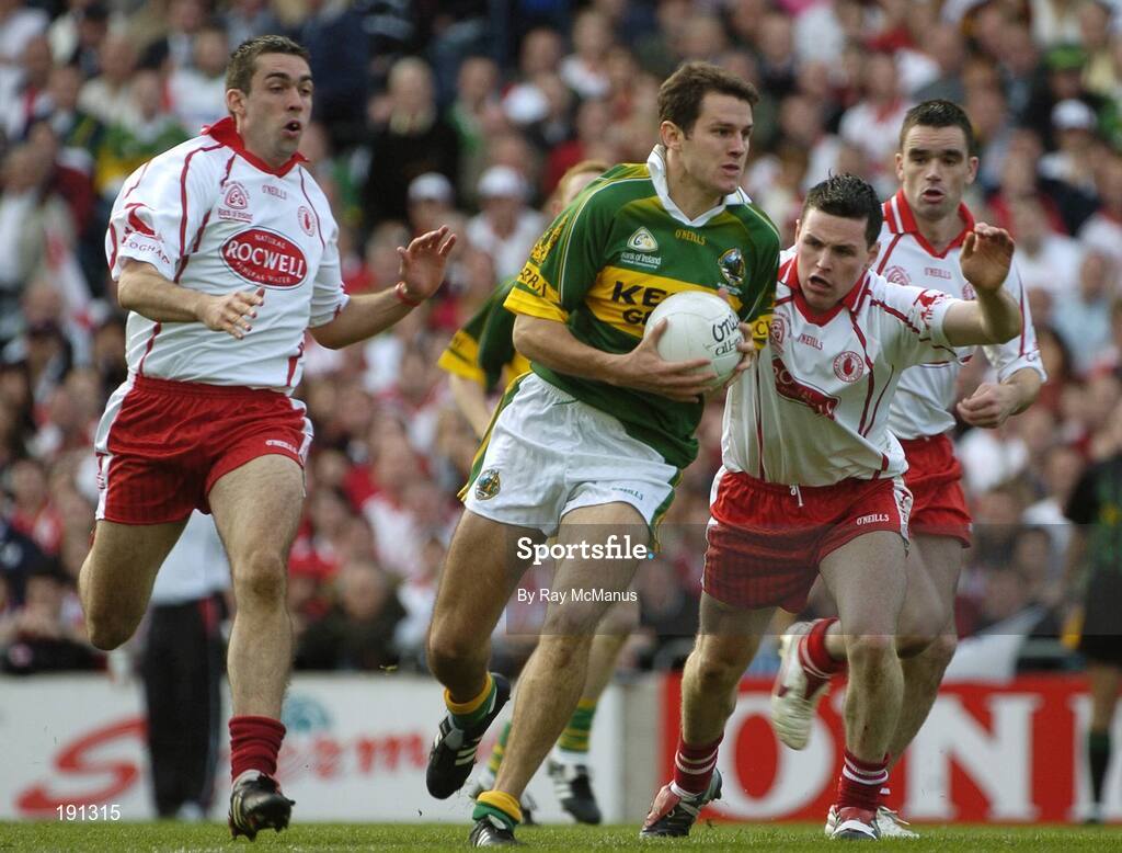 25 September 2005; Eoin Brosnan, Kerry, in action against Conor Gormley, centre, Ryan McMenamin, right, and Michael McGee, left, Tyrone. Bank of Ireland All-Ireland Senior Football Championship Final, Kerry v Tyrone, Croke Park, Dublin. Picture credit; Ray McManus / SPORTSFILE *** Local Caption *** Any photograph taken by SPORTSFILE during, or in connection with, the 2005 Bank of Ireland All-Ireland Senior Football Final which displays GAA logos or contains an image or part of an image of any GAA intellectual property, or, which contains images of a GAA player/players in their playing uniforms, may only be used for editorial and non-advertising purposes.  Use of photographs for advertising, as posters or for purchase separately is strictly prohibited unless prior written approval has been obtained from the Gaelic Athletic Association.