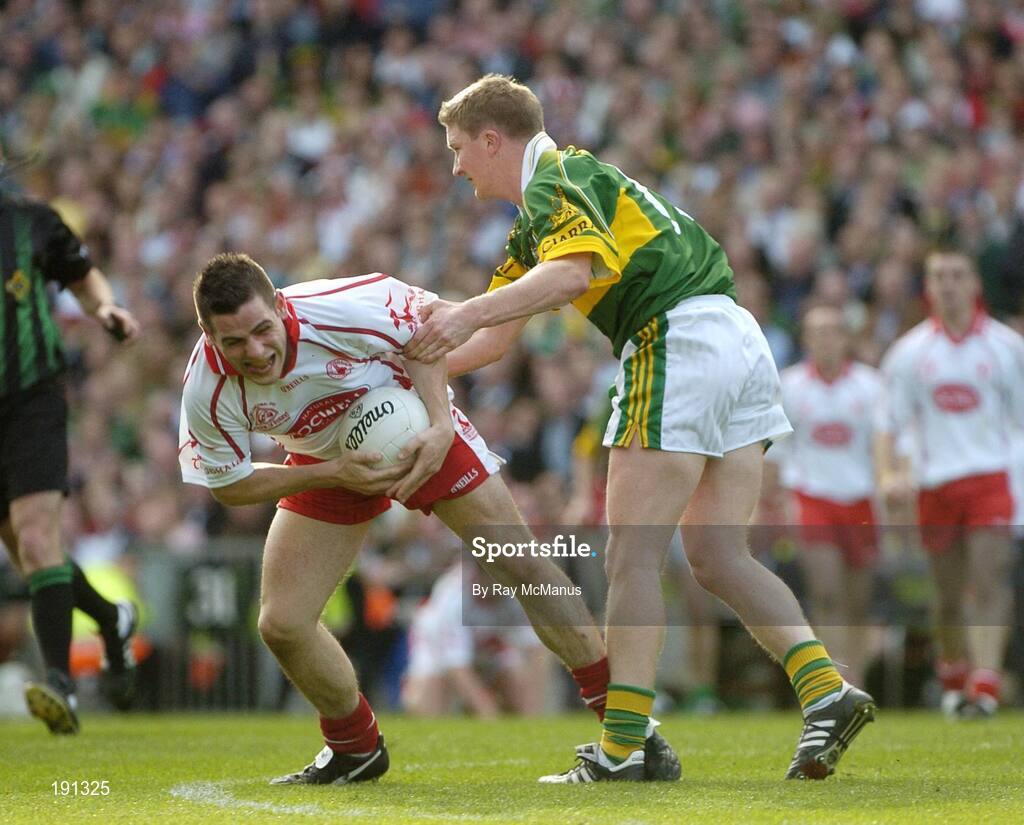 25 September 2005; Michael McGee, Tyrone, in action against Mike Frank Russell, Kerry. Bank of Ireland All-Ireland Senior Football Championship Final, Kerry v Tyrone, Croke Park, Dublin. Picture credit; Ray McManus / SPORTSFILE *** Local Caption *** Any photograph taken by SPORTSFILE during, or in connection with, the 2005 Bank of Ireland All-Ireland Senior Football Final which displays GAA logos or contains an image or part of an image of any GAA intellectual property, or, which contains images of a GAA player/players in their playing uniforms, may only be used for editorial and non-advertising purposes.  Use of photographs for advertising, as posters or for purchase separately is strictly prohibited unless prior written approval has been obtained from the Gaelic Athletic Association.