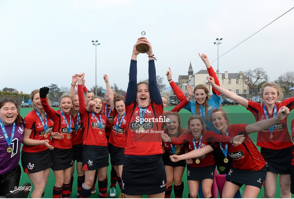 28 March 2014; Hannah Grieve, Lurgan College, captain lifts the trophy as her team-mates celebrate. Electric Ireland Kate Russell All-Ireland School Girls Hockey Final Tournament, St Andrews College, Dublin v Lurgan College, Co. Armagh, St Andrews College, Booterstown, Co Dublin. Picture credit: Matt Browne / SPORTSFILE