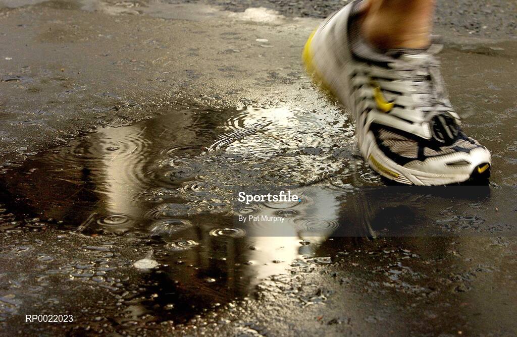 31 October 2005; An athlete splashes through a puddle during the 2005 adidas Dublin City Marathon. Picture credit: Pat Murphy / SPORTSFILE
