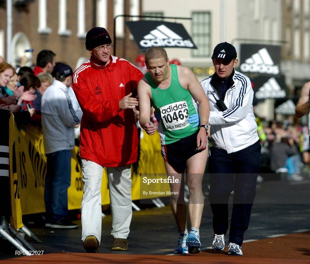 31 October 2005; Diarmuid McDonnell is helped over the finish line by race officials during the 2005 adidas Dublin City Marathon. Picture credit: Brendan Moran / SPORTSFILE