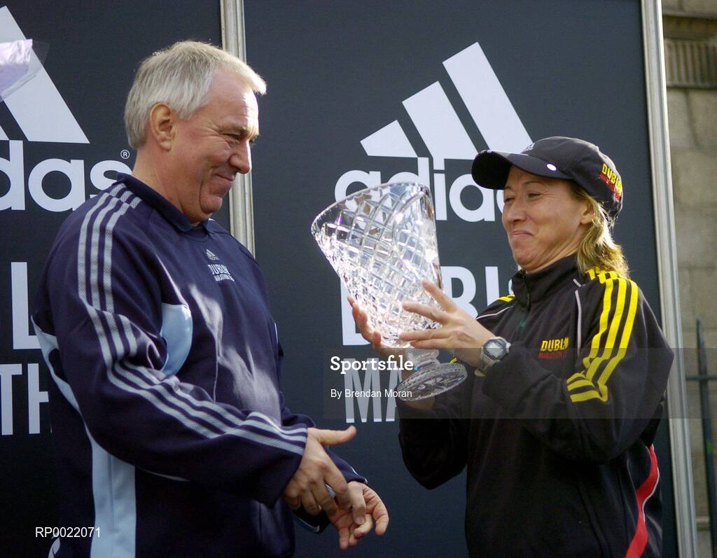 31 October 2005; Women's race winner Zinaida Semenova of Russia is presented with her trophy by Robin Money, Head of Sports Marketing, adidas Area North, during the 2005 adidas Dublin City Marathon. Picture credit: Brendan Moran / SPORTSFILE