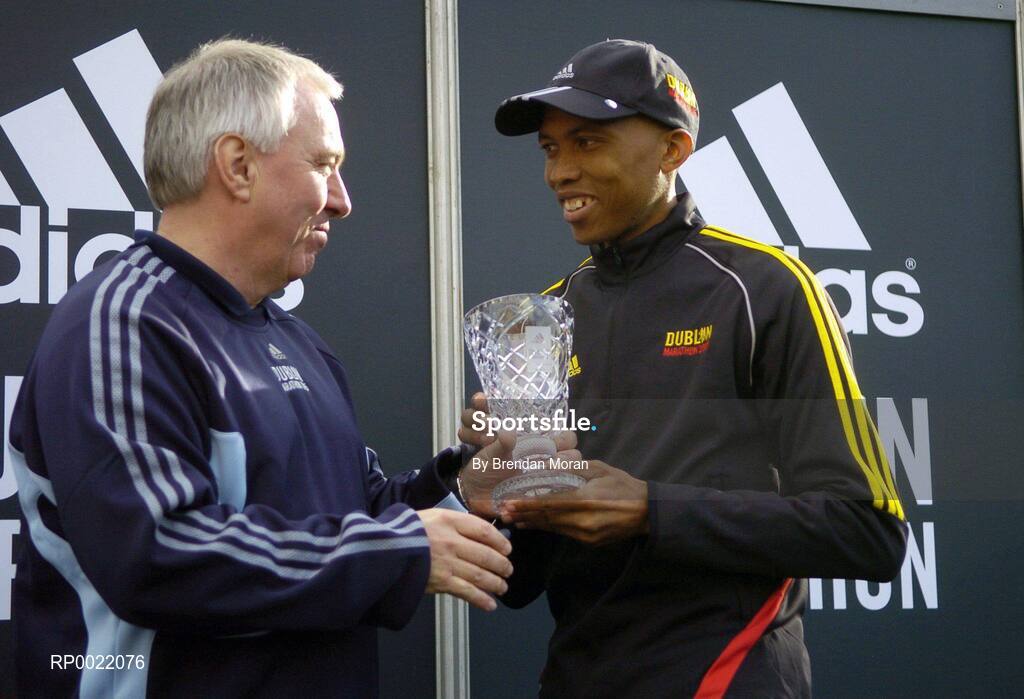 31 October 2005; 2nd placed Neo Molema of South Africa, is presented with his trophy by Robin Money, Head of Sports Marketing, adidas Area North, during the 2005 adidas Dublin City Marathon. Picture credit: Brendan Moran / SPORTSFILE