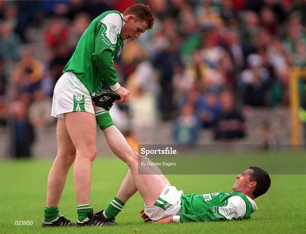 30 May 1999; Paul Brewster Fermanagh helps his team-mate Raymond Johnston with cramp during the Bank of Ireland Ulster Senior Football Championship Preliminary Round match between Monaghan and Fermanagh at St Tiernach's Park in Clones, Monaghan. Photo by Damien Eagers/Sportsfile