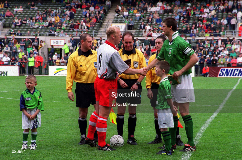 29 May 1999; Northern Ireland captain Iain Dowie shakes hands with Republic of Ireland captain Niall Quinn, watched by Northern Ireland mascot Anthony Brady and Republic of Ireland mascot Christopher Gallagher during the International Friendly match between Republic of Ireland and Northern Ireland at Lansdowne Road in Dublin. Photo by Ray McManus/Sportsfile