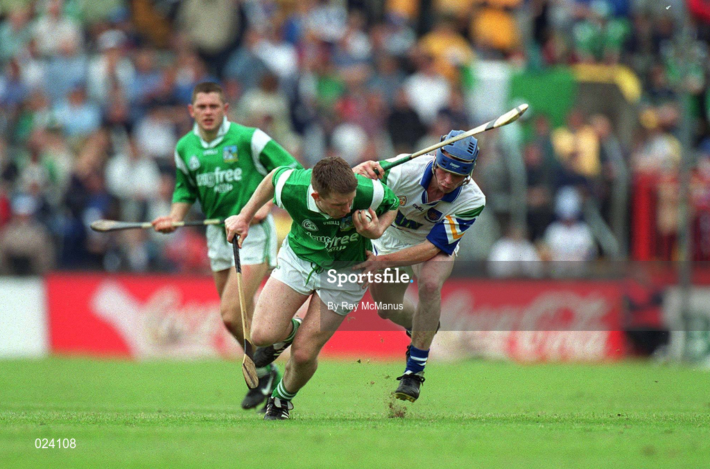 30 May 1999; Mark Foley of Limerick in action against Brian Greene of Waterford during the Guinness Munster Senior Hurling Championship Quarter-Final match between Limerick and Waterford at Páirc Uí Chaoimh in Cork. Photo by Ray McManus/Sportsfile