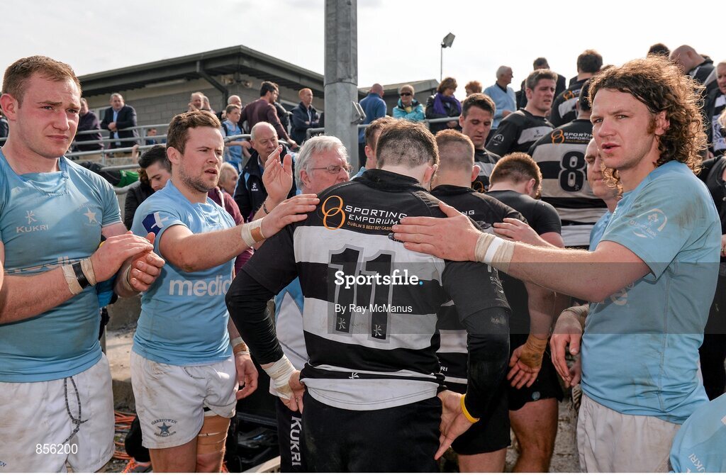 19 April 2014; Philip O'Dwyer, Old Belvedere, is comforted by Garryowen players as he and his team-mates leave the pitch after the game. Ulster Bank League Division 1A, Garryowen v Old Belvedere, Dooradoyle, Limerick. Picture credit: Ray McManus / SPORTSFILE