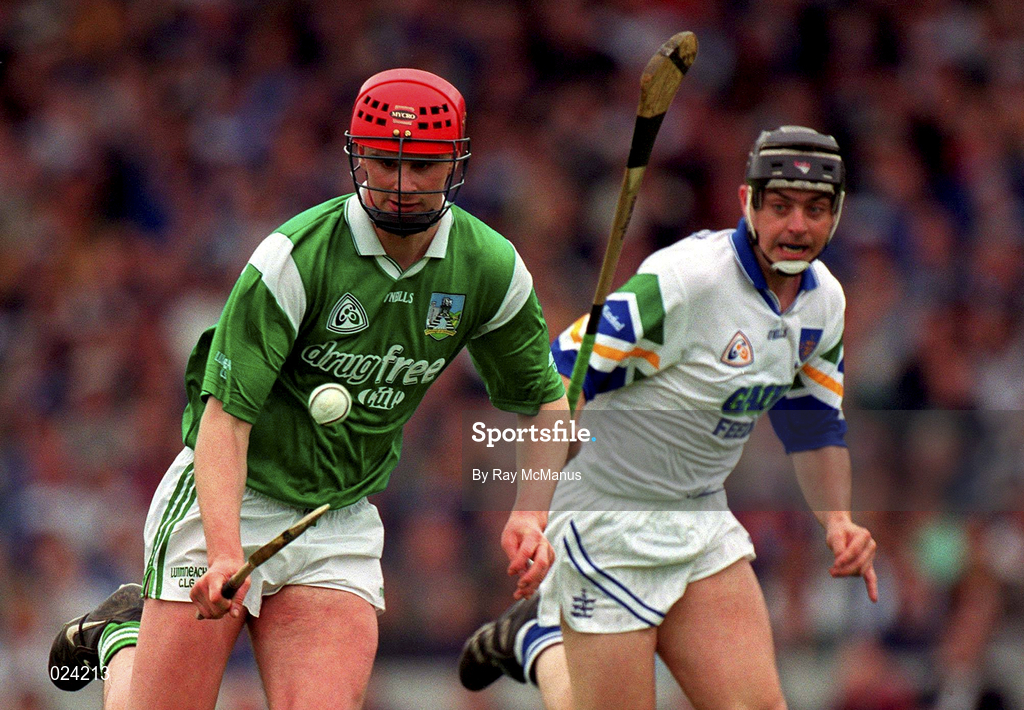 30 May 1999; Brian Begley of Limerick  in action against Paul Flynn of Waterford during the Guinness Munster Senior Hurling Championship quarter-final match between Limerick and Waterford at Páirc Uí Chaoimh in Cork. Photo by Ray McManus/Sportsfile