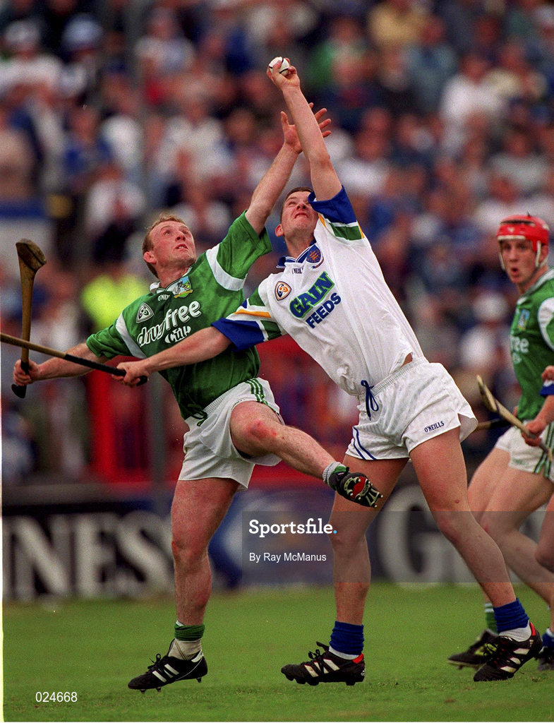 30 May 1999; Ken McGrath of Waterford wins possession ahead of Dave Clarke of Limerick during the Guinness Munster Senior Hurling Championship quarter-final match between Limerick and Waterford at Páirc Uí Chaoimh in Cork. Photo by Ray McManus/Sportsfile