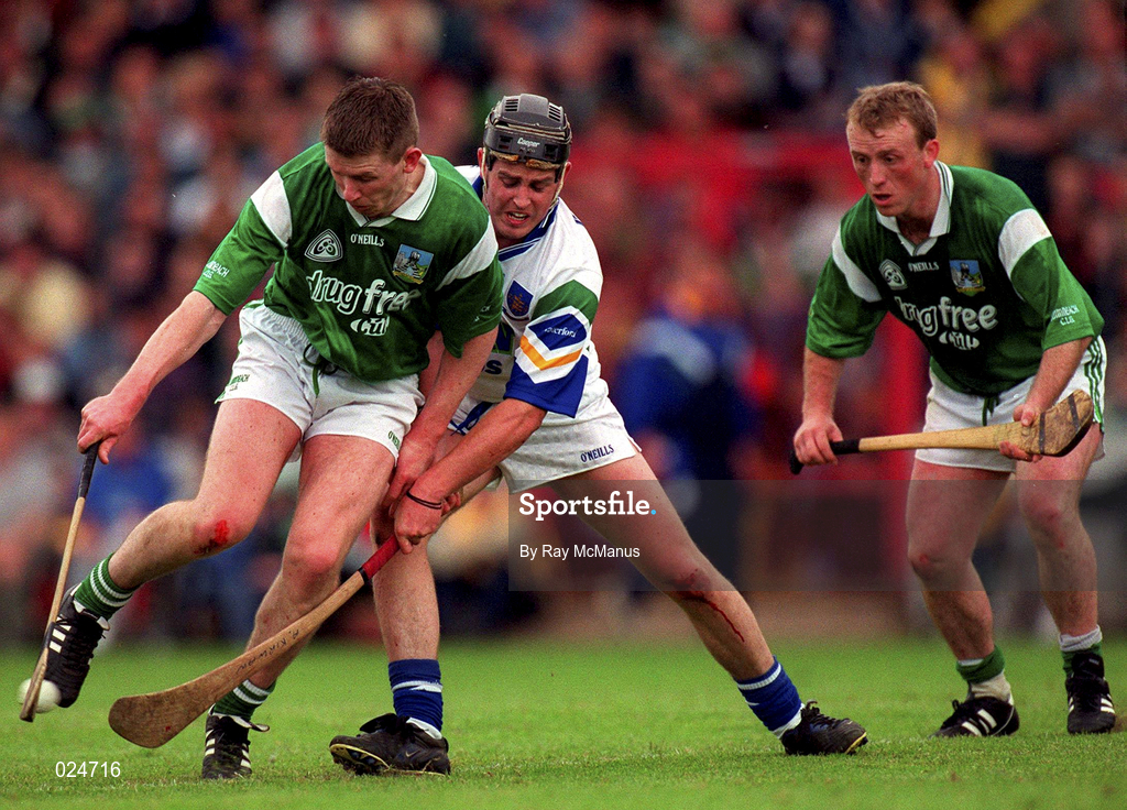 30 May 1999; Mark Foley, supported by Limerick team-mate Dave Clarke, in action against Anthony Kirwan of Waterford during the Guinness Munster Senior Hurling Championship quarter-final match between Limerick and Waterford at Páirc Uí Chaoimh in Cork. Photo by Ray McManus/Sportsfile