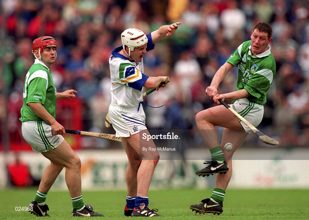 30 May 1999; Ciaran Carey, right, supported by Limerick team-mate TJ Ryan in action against Fergal Hartley of Waterford during the Guinness Munster Senior Hurling Championship quarter-final match between Limerick and Waterford at Páirc Uí Chaoimh in Cork. Photo by Ray McManus/Sportsfile