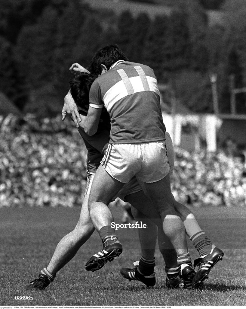 15 June 1986; Willie Brennan, Laois, gets to grips with Wicklow's Nick O'Neill during the game. Leinster Football Championship, Wicklow v Laois, County Park, Aughrim, Co. Wicklow. Picture credit; Ray McManus / SPORTSFILE
