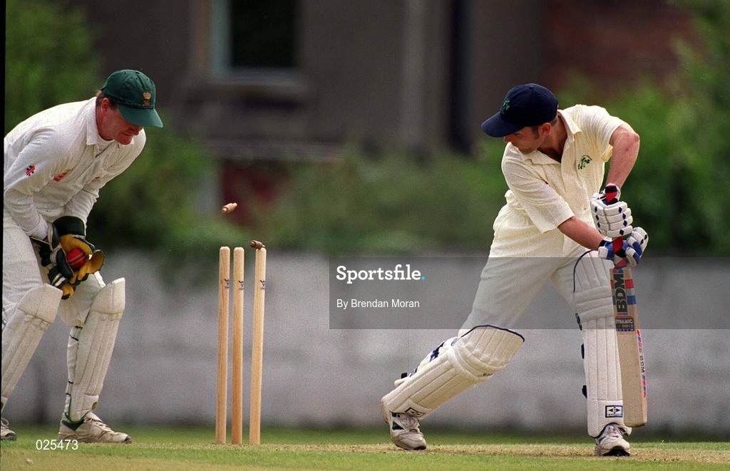 30 June 1999; Gordon Cooke of Ireland is bowled out by Jamie Sylvester of Wales as wicketkeeper Roger Clitheroe collects the ball during the Triple Crown Tournament match between Ireland and Wales at Leinster Cricket Club in Dublin. Photo by Brendan Moran/Sportsfile
