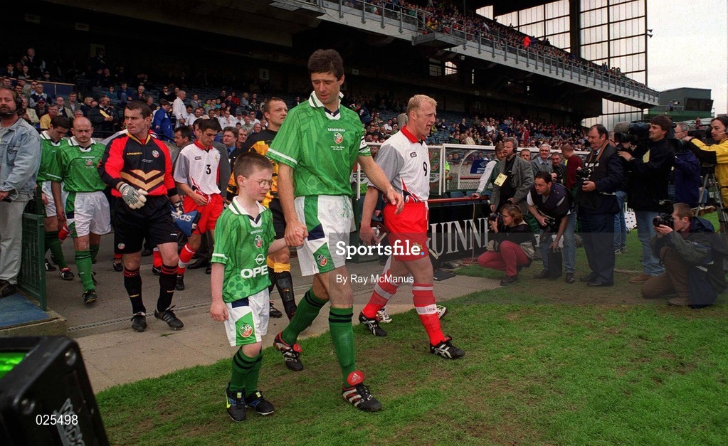 29 May 1999; Niall Quinn of Republic of Ireland with mascot Christopher Gallagher and Iain Dowie of Northern Ireland walk out prior to the International Friendly match between Republic of Ireland and Northern Ireland at Lansdowne Road in Dublin. Photo by Ray McManus/Sportsfile