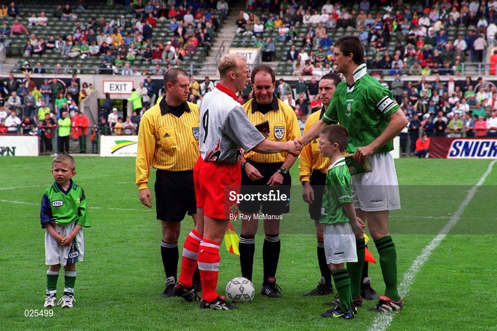 29 May 1999; Iain Dowie Northern Ireland and Niall Quinn of Republic of Ireland shake hands watched by Republic of Ireland mascot Christopher Gallagher, right, and Northern Ireland Mascot Anthony Brady, left, prior to the International Friendly match between Republic of Ireland and Northern Ireland at Lansdowne Road in Dublin. Photo by Ray McManus/Sportsfile