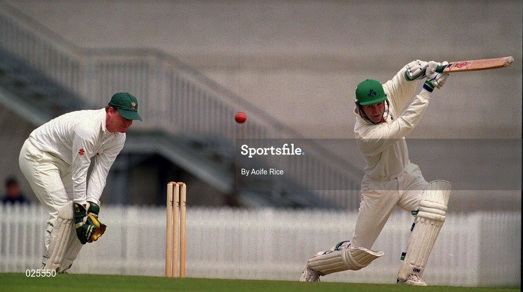30 June 1999; John Davy of Ireland hits a four as Roger Clitheroe of Wales looks on during the Triple Crown Tournament match between Ireland and Wales at Leinster Cricket Club in Dublin. Photo by Aoife Rice/Sportsfile